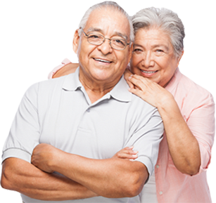 A multi-ethnic elderly couple embrace and smile