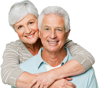 An elderly Caucasian couple embrace and smile