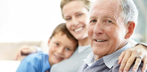 Three generations smile for the camera - a grandfather, his daughter, and his grandson